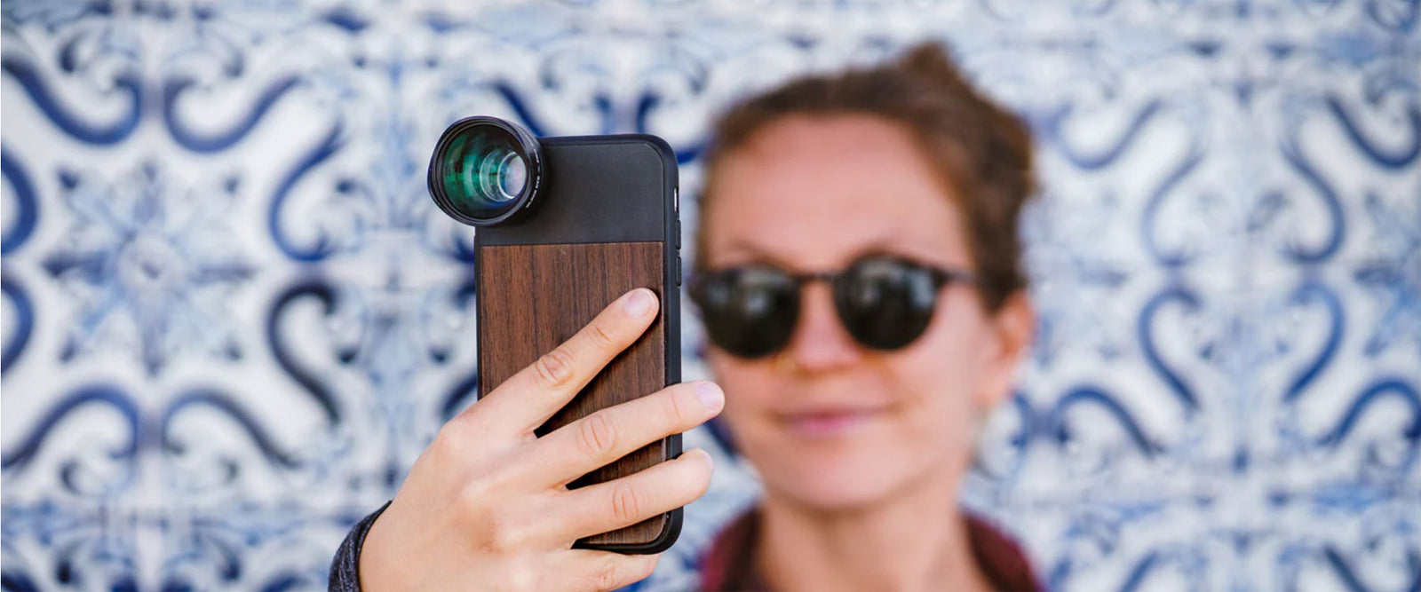 woman holding a phone with iphone lens