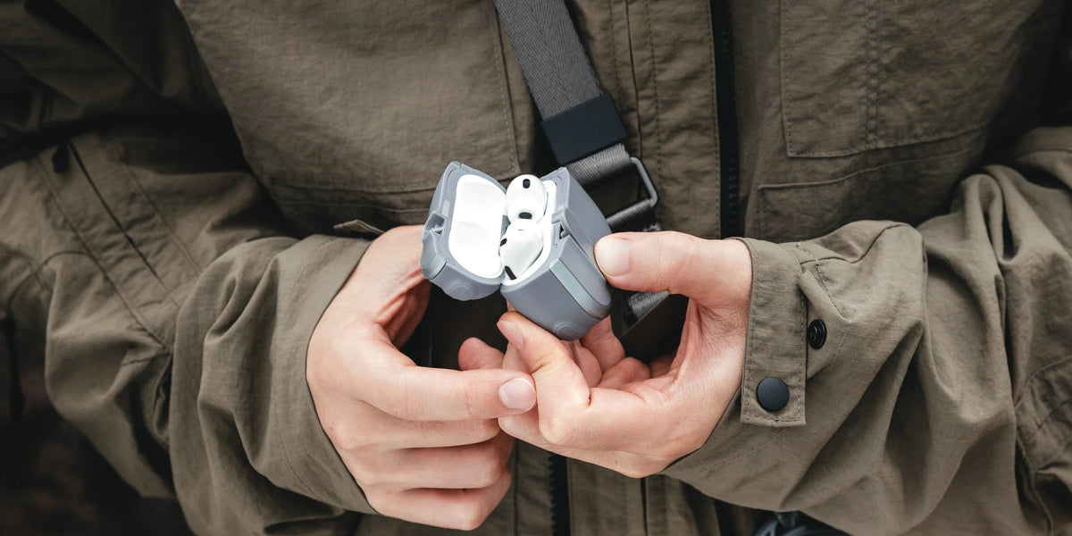 MAGEASY Odyssey outdoor AirPods Pro 3 case clipped beside a phone pouch for outdoor carry