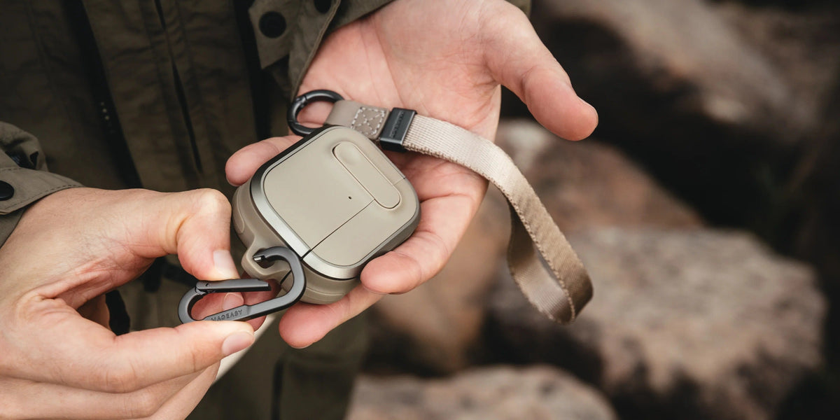 MAGEASY Odyssey outdoor AirPods Pro 3 case being opened outdoors while removing an earbud
